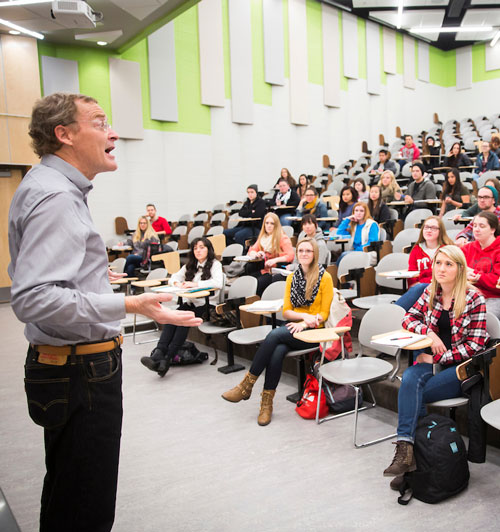 professor teaching a large auditorium of students